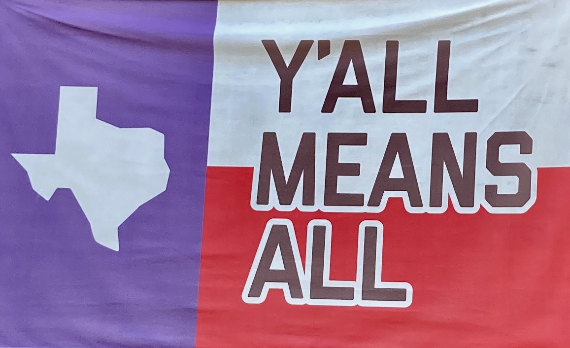 Text on photo reads "Y'all means all"